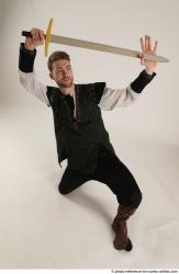 KEETA KNEELING POSE WITH SWORD